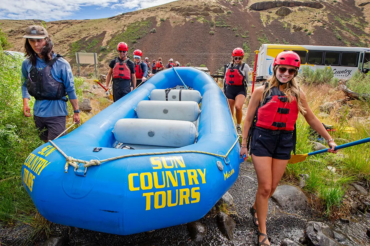 Group walking raft to river