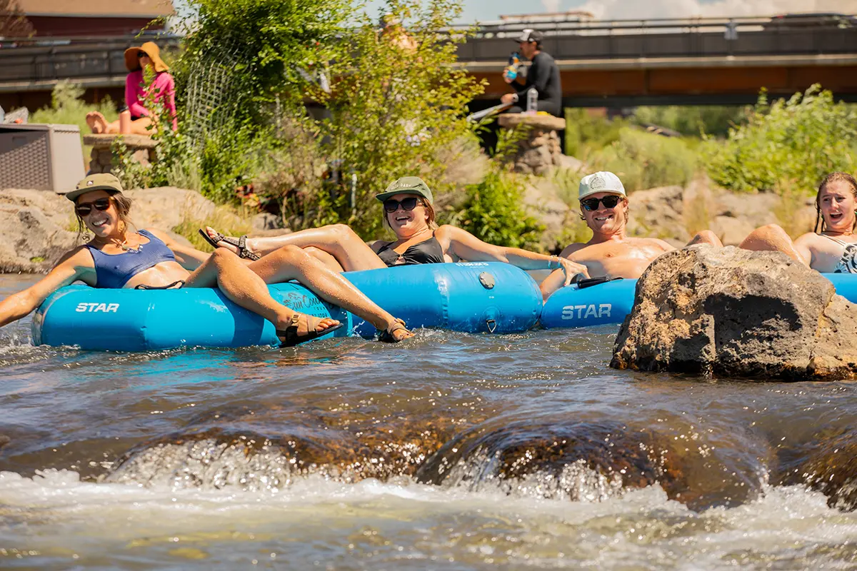 Friends floating the Deschutes River in Bend, on tubes rented from Sun Country Tours